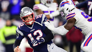 FOXBOROUGH, MASSACHUSETTS - DECEMBER 21: Tom Brady #12 of the New England Patriots is hit by Shaq Lawson #90 of the Buffalo Bills during the first half in the game at Gillette Stadium on December 21, 2019 in Foxborough, Massachusetts. (Photo by Billie Weiss/Getty Images)