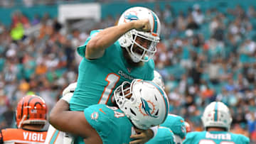 MIAMI, FLORIDA - DECEMBER 22: Ryan Fitzpatrick #14 and Christian Wilkins #94 of the Miami Dolphins celebrate touchdown against the Cincinnati Bengals in the first quarter at Hard Rock Stadium on December 22, 2019 in Miami, Florida. (Photo by Mark Brown/Getty Images)