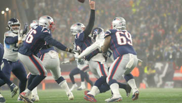 FOXBOROUGH, MASSACHUSETTS - JANUARY 04: Tom Brady #12 of the New England Patriots is hit as they take on the Tennessee Titans in the first half of the AFC Wild Card Playoff game at Gillette Stadium on January 04, 2020 in Foxborough, Massachusetts. (Photo by Kathryn Riley/Getty Images)