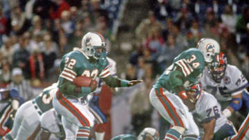 ORCHARD PARK, NY - SEPTEMBER 17: Running back Tony Nathan #22 of the Miami Dolphins runs with the football behind the blocking of running back Woody Bennett #34 during a Monday Night Football game against the Buffalo Bills at Rich Stadium on September 17, 1984 in Orchard Park, New York. The Dolphins defeated the Bills 21-17. (Photo by George Gojkovich/Getty Images)