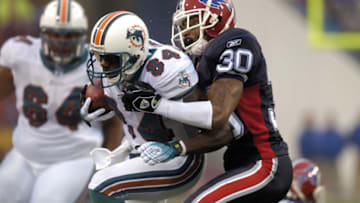Miami Dolphins # 30 Ko Simpson tackling Miami Dolpins #84 wide receiver Chris Chambers during Miami Dolphins vs Buffalo Bills on December 17, 2006 at Ralph Wilson Stadium in Orchard Park, New York Buffalo won 21-0. (Photo by Mark Konezny/NFLPhotoLibrary)