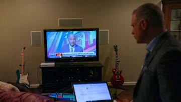MOUNT AIRY, MARYLAND - MARCH 18: With the NFL Network on the television, WBAL Sports Anchor/Reporter Pete Gilbert checks his computer following a stand-up report on the 2020 NFL Free Agency and the Baltimore Ravens in the basement of WBAL Chief Sports Photographer Jim Forner's home basement on March 18, 2020 in Mount Airy, Maryland. Like many other sportscasters, Gilbert, the National Sports Media Association 2019 Maryland Sportscaster of the Year, has had to adapt to changing times due to coronavirus. Because there are no live sporting events due to the coronavirus, he is no longer anchoring in-studio, and using make-shift studios like his colleague's home to report sports. (Photo by Patrick Smith/Getty Images)