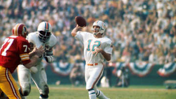 LOS ANGELES - JANUARY 14, 1973: Quarterback Bob Griese #12, of the Miami Dolphins, throws a pass during Super Bowl VII on January 14, 1973 against the Washington Redskins at the Coliseum in Los Angeles, California. Dolphins' guard Larry Little #66 blocks Bill Brundige #77 of the Redskins. Bob Griese7311 (Photo by: Kidwiler Collection/Diamond Images/Getty Images)