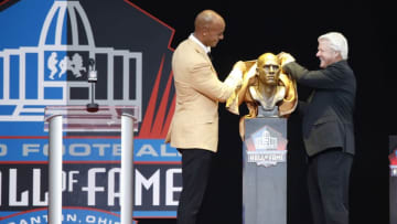 CANTON, OH - AUGUST 05: Jason Taylor and presenter Jimmie Johnson unveil Taylor's bust during the Pro Football Hall of Fame Enshrinement Ceremony at Tom Benson Hall of Fame Stadium on August 5, 2017 in Canton, Ohio. (Photo by Joe Robbins/Getty Images)
