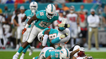 MIAMI, FL - AUGUST 09: Jerome Baker #55, Bobby McCain #28, and Minkah Fitzpatrick #29 of the Miami Dolphins make a tackle on Mike Evans #13 of the Tampa Bay Buccaneers in the first quarter during a preseason game at Hard Rock Stadium on August 9, 2018 in Miami, Florida. (Photo by Mark Brown/Getty Images)