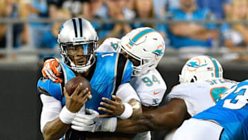 CHARLOTTE, NC - AUGUST 17: Robert Quinn #94 of the Miami Dolphins sacks Cam Newton #1 of the Carolina Panthers in the second quarter during the game at Bank of America Stadium on August 17, 2018 in Charlotte, North Carolina. (Photo by Grant Halverson/Getty Images)