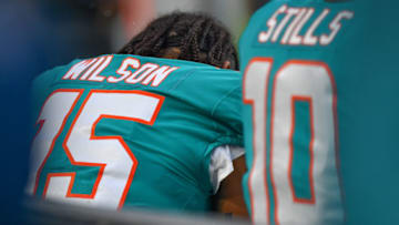MIAMI, FL - AUGUST 25: Albert Wilson #15 and Kenny Stills #10 of the Miami Dolphins sit on the bench during the National Anthem before the preseason game between the Miami Dolphins and the Baltimore Ravens at Hard Rock Stadium on August 25, 2018 in Miami, Florida. (Photo by Mark Brown/Getty Images)