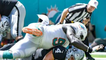 MIAMI, FL - SEPTEMBER 23: William Hayes #95 of the Miami Dolphins sacks Derek Carr #4 of the Oakland Raiders during the second quarter at Hard Rock Stadium on September 23, 2018 in Miami, Florida. (Photo by Mark Brown/Getty Images)