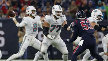 HOUSTON, TX - OCTOBER 25: Brock Osweiler #8 of the Miami Dolphins looks to pass as Jesse Davis #77 blocks Duke Ejiofor #53 of the Houston Texans in the second quarter at NRG Stadium on October 25, 2018 in Houston, Texas. (Photo by Tim Warner/Getty Images)