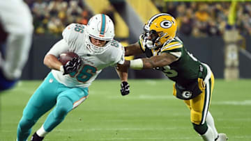 GREEN BAY, WI - NOVEMBER 11: Mike Gesicki #86 of the Miami Dolphins is tackled by Jaire Alexander #23 of the Green Bay Packers during the second half of a game at Lambeau Field on November 11, 2018 in Green Bay, Wisconsin. (Photo by Stacy Revere/Getty Images)