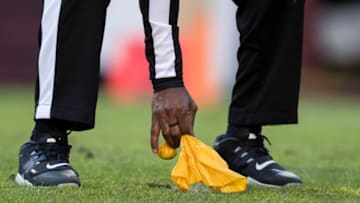 LANDOVER, MD - DECEMBER 15: A referee picks up a penalty flag during the first half of the game between the Washington Redskins and the Philadelphia Eagles at FedExField on December 15, 2019 in Landover, Maryland. (Photo by Scott Taetsch/Getty Images)