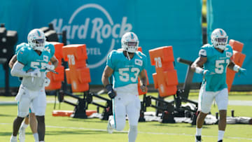 DAVIE, FLORIDA - AUGUST 31: Jerome Baker #55, Kyle Van Noy #53 and Kamu Grugier-Hill #51 of the Miami Dolphins look on during training camp at Baptist Health Training Facility at Nova Southern University on August 31, 2020 in Davie, Florida. (Photo by Michael Reaves/Getty Images)