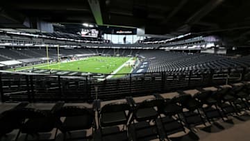 LAS VEGAS, NEVADA - DECEMBER 26: Empty seats are shown as players warm up before a game between the Miami Dolphins and the Las Vegas Raiders at Allegiant Stadium on December 26, 2020 in Las Vegas, Nevada. NFL games at the stadium are being played without fans in attendance because of the coronavirus (COVID-19) pandemic. (Photo by Ethan Miller/Getty Images)