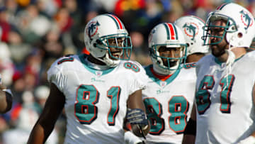 ORCHARD PARK, NY - DECEMBER 21: Tight end Randy McMichael #81 and center Tim Ruddy #61 of the Miami Dolphins talk on the field during the game against the Buffalo Bills on December 21, 2003 at Ralph Wilson Stadium in Orchard Park, New York. Miami won 20-3. (Photo by Rick Stewart/Getty Images)