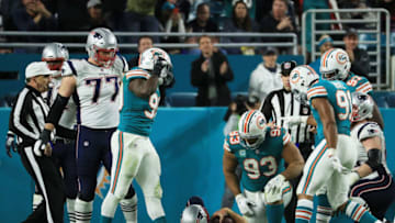 MIAMI GARDENS, FL - DECEMBER 11: Charles Harris #90 Cameron Wake #91 and Ndamukong Suh #93 of the Miami Dolphins celebrate sacking Tom Brady #12 of the New England Patriots in the fourth quarter at Hard Rock Stadium on December 11, 2017 in Miami Gardens, Florida. (Photo by Mike Ehrmann/Getty Images)
