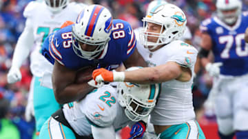 ORCHARD PARK, NY - DECEMBER 17: Charles Clay #85 of the Buffalo Bills runs with the ball as T.J. McDonald #22 of the Miami Dolphins and teammate Kiko Alonso #47 attempt to tackle Clay during the second quarter on December 17, 2017 at New Era Field in Orchard Park, New York. (Photo by Tom Szczerbowski/Getty Images)