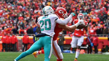 KANSAS CITY, MO - DECEMBER 24: Tight end Travis Kelce #87 of the Kansas City Chiefs catches the games first touchdown in front of free safety Reshad Jones #20 of the Miami Dolphins during the first half of the game at Arrowhead Stadium on December 24, 2017 in Kansas City, Missouri. ( Photo by Peter Aiken/Getty Images )