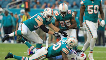 MIAMI GARDENS, FL - DECEMBER 31: Reshad Jones #20 of the Miami Dolphins tackles Marcus Murphy #45 of the Buffalo Bills during the second quarter at Hard Rock Stadium on December 31, 2017 in Miami Gardens, Florida. (Photo by Mike Ehrmann/Getty Images)