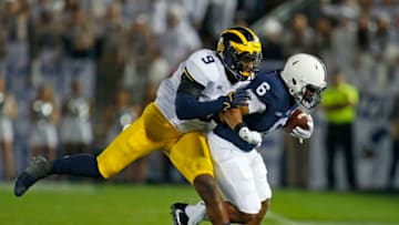 STATE COLLEGE, PA - OCTOBER 21: Mike McCray #9 of the Michigan Wolverines wraps up Andre Robinson #6 of the Penn State Nittany Lions on October 21, 2017 at Beaver Stadium in State College, Pennsylvania. (Photo by Justin K. Aller/Getty Images)