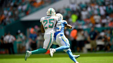 MIAMI, FLORIDA - SEPTEMBER 29: Xavien Howard #25 of the Miami Dolphins attempts to break up the pass to Dontrelle Inman #15 of the Los Angeles Chargers in the second quarter at Hard Rock Stadium on September 29, 2019 in Miami, Florida. (Photo by Mark Brown/Getty Images)