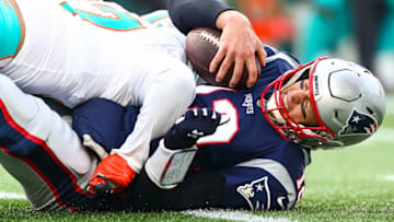 FOXBOROUGH, MA - DECEMBER 29: Trent Harris #97 of the Miami Dolphins sacks Tom Brady #12 of the New England Patriots during a game at Gillette Stadium on December 29, 2019 in Foxborough, Massachusetts. (Photo by Adam Glanzman/Getty Images)
