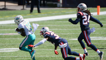 FOXBOROUGH, MA - SEPTEMBER 13: Jakeem Grant Sr. #19 of the Miami Dolphins breaks away from the tackle of Devin McCourty #32 of the New England Patriots in the first half at Gillette Stadium on September 13, 2020 in Foxborough, Massachusetts. (Photo by Kathryn Riley/Getty Images)