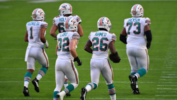 MIAMI GARDENS, FLORIDA - NOVEMBER 15: Miami Dolphins head back to the sidelines after scoring against the Los Angeles Chargers at Hard Rock Stadium on November 15, 2020 in Miami Gardens, Florida. (Photo by Mark Brown/Getty Images)