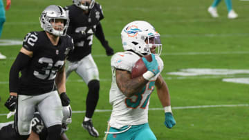 LAS VEGAS, NEVADA - DECEMBER 26: Running back Myles Gaskin #37 of the Miami Dolphins scores a touchdown on a 59-yard pass play ahead of safety Dallin Leavitt #32 of the Las Vegas Raiders in the second half of their game at Allegiant Stadium on December 26, 2020 in Las Vegas, Nevada. The Dolphins defeated the Raiders 26-25. (Photo by Ethan Miller/Getty Images)