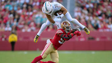 SANTA CLARA, CALIFORNIA - DECEMBER 04: Alec Ingold #30 of the Miami Dolphins leaps over would be tackler Dre Greenlaw #57 of the San Francisco 49ers during the second quarter of an NFL football game at Levi's Stadium on December 04, 2022 in Santa Clara, California. (Photo by Thearon W. Henderson/Getty Images)