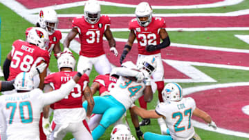 Nov 8, 2020; Glendale, Arizona, USA; Miami Dolphins running back Jordan Howard (34) runs for a touchdown against the Arizona Cardinals during the first half at State Farm Stadium. Mandatory Credit: Matt Kartozian-USA TODAY Sports