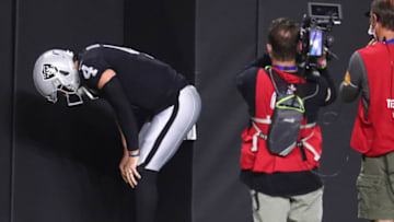 Dec 17, 2020; Paradise, Nevada, USA;Las Vegas Raiders quarterback Derek Carr (4) reacts after suffering an apparent injury against the Los Angeles Chargers during the first half at Allegiant Stadium. Mandatory Credit: Mark J. Rebilas-USA TODAY Sports