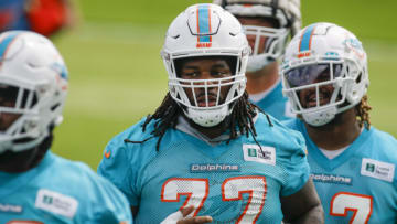 Jun 2, 2022; Miami Gardens, Florida, USA; Miami Dolphins defensive tackle John Jenkins (77) runs on the field during minicamp at Baptist Health Training Complex. Mandatory Credit: Sam Navarro-USA TODAY Sports