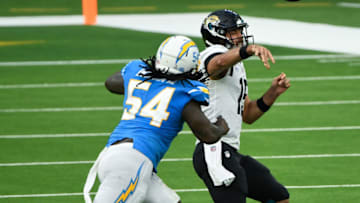 Oct 25, 2020; Inglewood, California, USA; Jacksonville Jaguars quarterback Gardner Minshew (15) gets off a pass under pressure from Los Angeles Chargers defensive end Melvin Ingram (54) at SoFi Stadium. Mandatory Credit: Robert Hanashiro-USA TODAY Sports