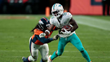 Nov 22, 2020; Denver, Colorado, USA; Miami Dolphins running back Salvon Ahmed (26) is tackled by Denver Broncos linebacker Alexander Johnson (45) in the fourth quarter at Empower Field at Mile High. Mandatory Credit: Isaiah J. Downing-USA TODAY Sports