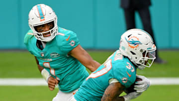 Dec 6, 2020; Miami Gardens, Florida, USA; Miami Dolphins quarterback Tua Tagovailoa (1) hands the ball to running back Myles Gaskin (37) during the second half against the Cincinnati Bengals at Hard Rock Stadium. Mandatory Credit: Jasen Vinlove-USA TODAY Sports