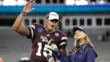 Dec 30, 2015; Charlotte, NC, USA; Mississippi State Bulldogs quarterback Dak Prescott (15) accepts the Belk Bowl MVP trophy after defeating the North Carolina State Wolfpack in the 2015 Belk Bowl at Bank of America Stadium. The Bulldogs defeated the Wolfpack 51-28. Mandatory Credit: Jeremy Brevard-USA TODAY Sports
