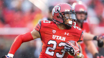 Nov 22, 2014; Salt Lake City, UT, USA; Utah Utes running back Devontae Booker (23) runs with the ball during the first half against the Arizona Wildcats at Rice-Eccles Stadium. Mandatory Credit: Russ Isabella-USA TODAY Sports