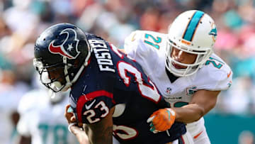 Oct 25, 2015; Miami Gardens, FL, USA; Miami Dolphins cornerback Brent Grimes (21) tackles Houston Texans running back Arian Foster (23) during the second half at Sun Life Stadium. The Dolphins won 44-26. Mandatory Credit: Steve Mitchell-USA TODAY Sports
