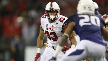 Nov 7, 2015; Seattle, WA, USA; Utah Utes running back Devontae Booker (23) rushes against the Washington Huskies during the fourth quarter at Husky Stadium. Booker had 150 yards rushing and a touchdown. Utah won 34-23. Mandatory Credit: Jennifer Buchanan-USA TODAY Sports