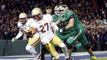 Nov 21, 2015; Boston, MA, USA; Boston College Eagles defensive back Justin Simmons (27) makes an interception during the third quarter against the Notre Dame Fighting Irish at Fenway Park. Mandatory Credit: Greg M. Cooper-USA TODAY Sports