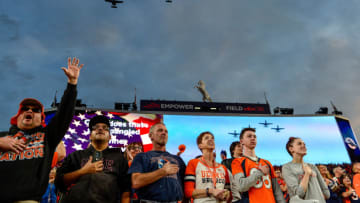 DENVER, CO - OCTOBER 17: Denver Broncos fans stand during the performance of the national anthem as a group of A-10 fighter jets perform a flyover before a game between the Denver Broncos and the Kansas City Chiefs at Empower Field at Mile High on October 17, 2019 in Denver, Colorado. (Photo by Dustin Bradford/Getty Images)