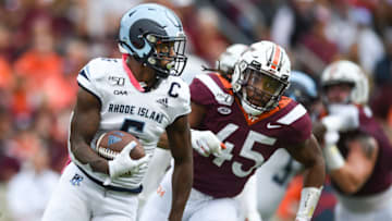 BLACKSBURG, VA - OCTOBER 12: Wide receiver Aaron Parker #6 of the Rhode Island Rams carries the ball while being pursued by defensive lineman TyJuan Garbutt #45 of the Virginia Tech Hokies in the first half at Lane Stadium on October 12, 2019 in Blacksburg, Virginia. (Photo by Michael Shroyer/Getty Images)