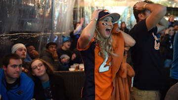CHARLOTTE, NC - FEBRUARY 07: A fan of the Denver Broncos celebrates while watching Super Bowl 50 on February 7, 2016 at Rooftop 210 in the EpiCentre area of uptown Charlotte, North Carolina. (Photo by Lance King/Getty Images)