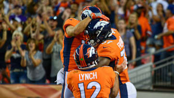 DENVER, CO - AUGUST 11: Running back Royce Freeman #37 of the Denver Broncos celebrates with quarterback Paxton Lynch #12 after a second quarter touchdown against the Minnesota Vikings during an NFL preseason game at Broncos Stadium at Mile High on August 11, 2018 in Denver, Colorado. (Photo by Dustin Bradford/Getty Images)