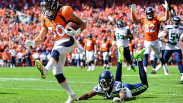 DENVER, CO - SEPTEMBER 9: Running back Phillip Lindsay #30 of the Denver Broncos of the Denver Broncos scores a first quarter touchdown on a reception as cornerback Tre Flowers #37 of the Seattle Seahawks falls to the ground during a game at Broncos Stadium at Mile High on September 9, 2018 in Denver, Colorado. (Photo by Dustin Bradford/Getty Images)