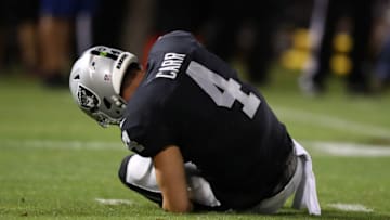 OAKLAND, CA - SEPTEMBER 10: Derek Carr #4 of the Oakland Raiders grabs his ankle after a play against the Los Angeles Rams during their NFL game at Oakland-Alameda County Coliseum on September 10, 2018 in Oakland, California. (Photo by Ezra Shaw/Getty Images)