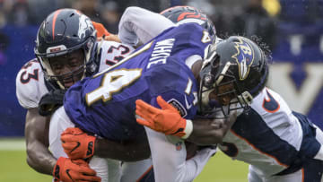 BALTIMORE, MD - SEPTEMBER 23: Tim White #14 of the Baltimore Ravens is tackled Joe Jones #43 and Shamarko Thomas #38 of the Denver Broncos during the first half at M&T Bank Stadium on September 23, 2018 in Baltimore, Maryland. (Photo by Scott Taetsch/Getty Images)