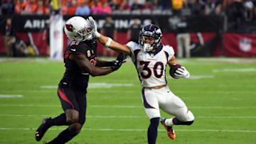 GLENDALE, AZ - OCTOBER 18: Running back Phillip Lindsay #30 of the Denver Broncos stiff arms cornerback Patrick Peterson #21 of the Arizona Cardinals during the first quarter at State Farm Stadium on October 18, 2018 in Glendale, Arizona. (Photo by Norm Hall/Getty Images)