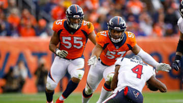 DENVER, CO - NOVEMBER 4: Quarterback Deshaun Watson #4 of the Houston Texans drops to the ground to avoid a hit by defensive end DeMarcus Walker #57 and outside linebacker Bradley Chubb #55 of the Denver Broncos in the second quarter of a game at Broncos Stadium at Mile High on November 4, 2018 in Denver, Colorado. (Photo by Justin Edmonds/Getty Images)