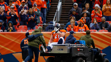 DENVER, CO - NOVEMBER 4: Center Matt Paradis #61 of the Denver Broncos puts his hand on his head as he is carted of the field with an injury in the second quarter of a game against the Houston Texans at Broncos Stadium at Mile High on November 4, 2018 in Denver, Colorado. (Photo by Justin Edmonds/Getty Images)